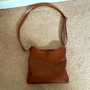 Brown crossbody faux leather bag with gold zippers and buckle